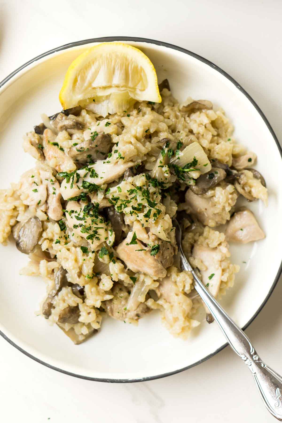 Close up of Oven Baked Chicken and Mushroom Risotto with a fork