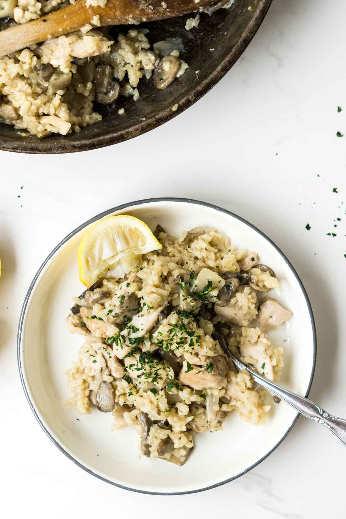 Oven Baked Chicken and Mushroom Risotto on a place with a fork