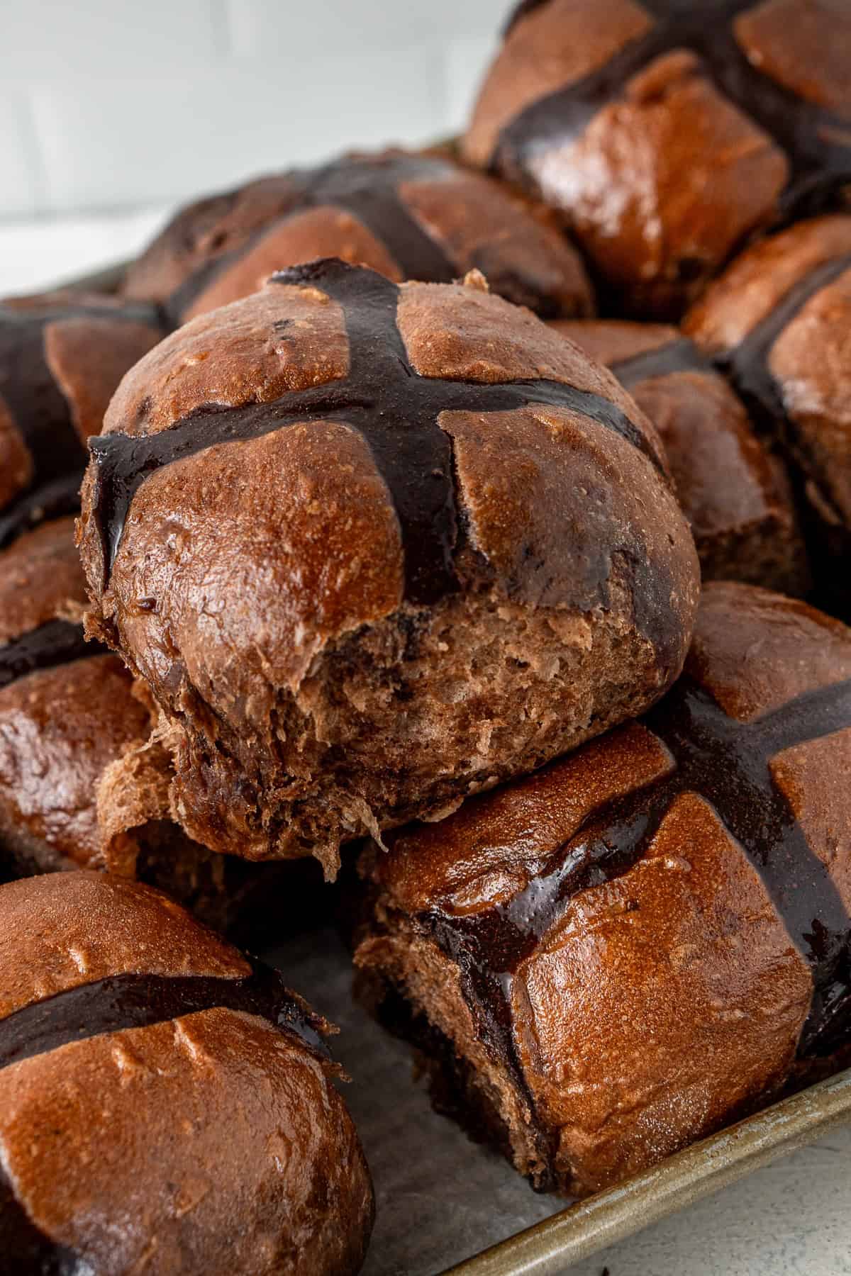 Close up of chocolate hot cross buns.
