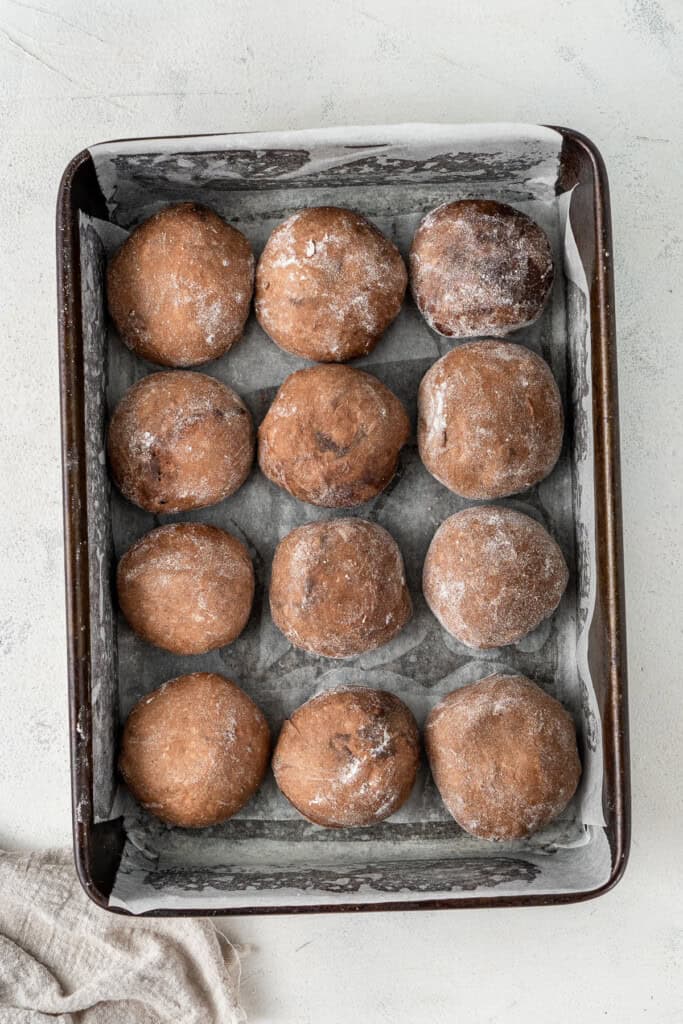 The dough balls in a baking tray.