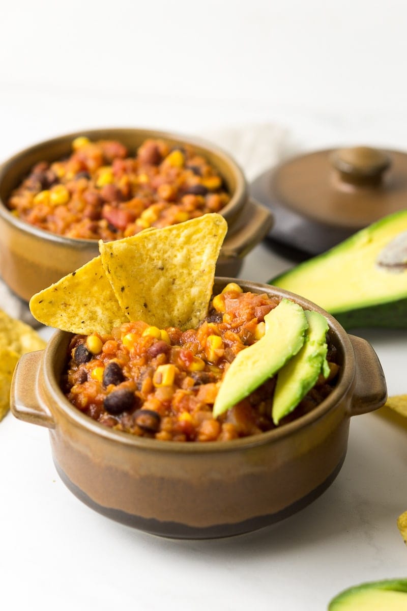 Vegan Slow Cooker Lentil Chilli with corn chips and avocado