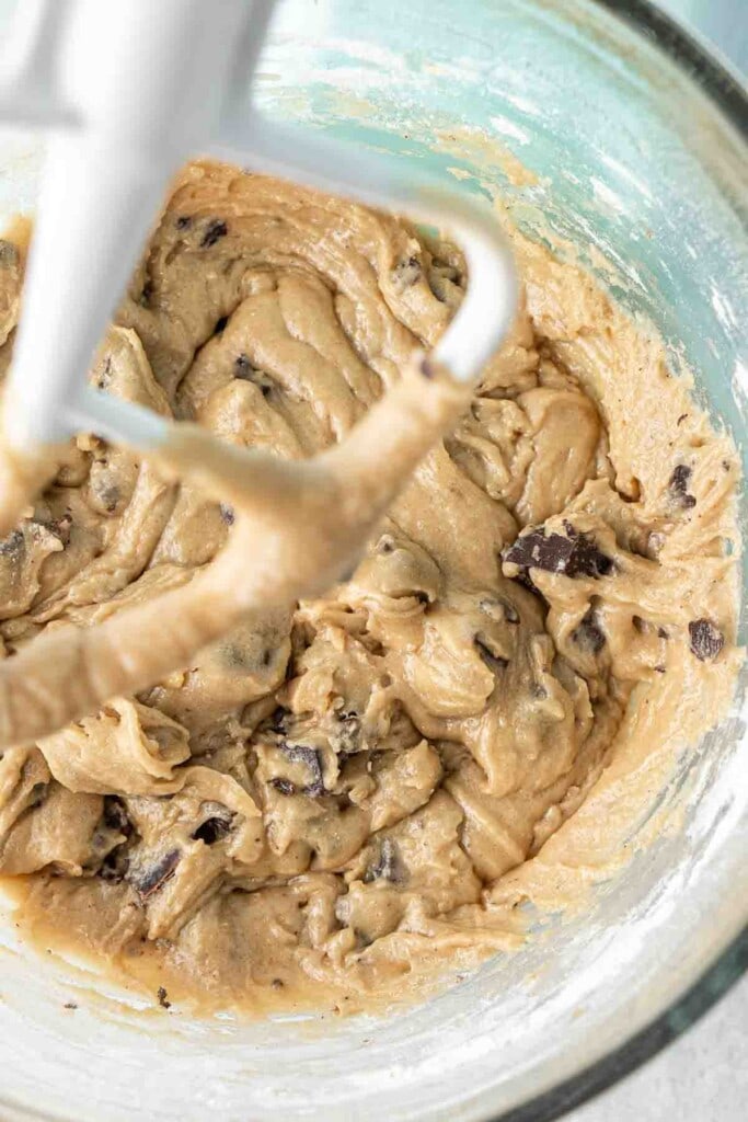 Cookie dough in the bowl of a stand mixer.