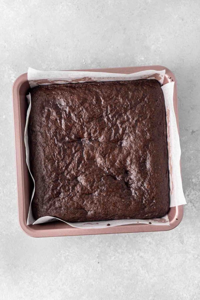 Cooked brownies in a square baking pan.