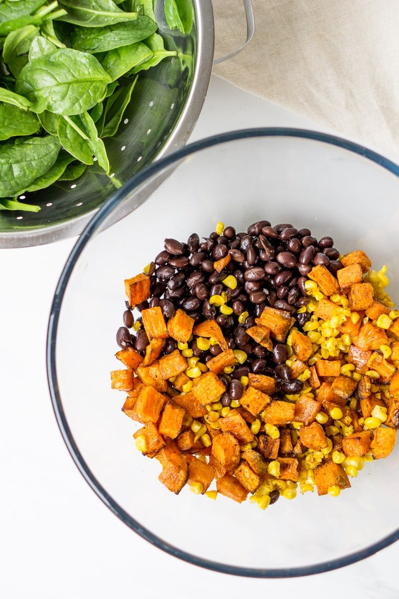 Spinach, sweet potato, corn and black beans in a bowl