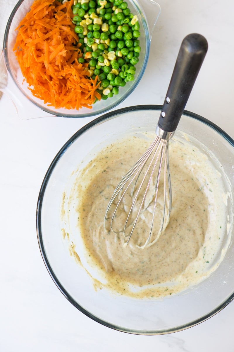 Vegetables and fritter batter in a bowl