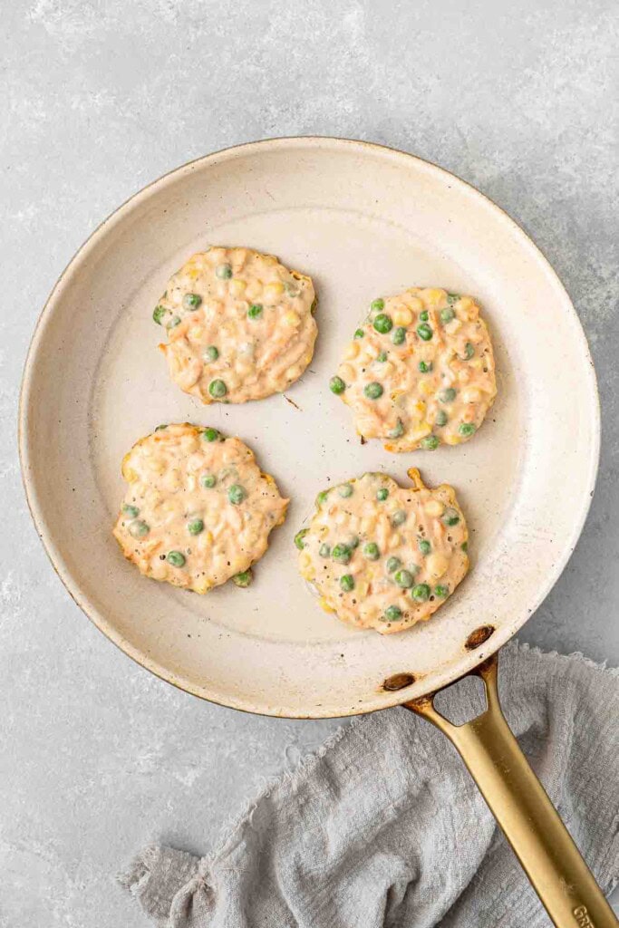 The fritter batter in a large frying pan.