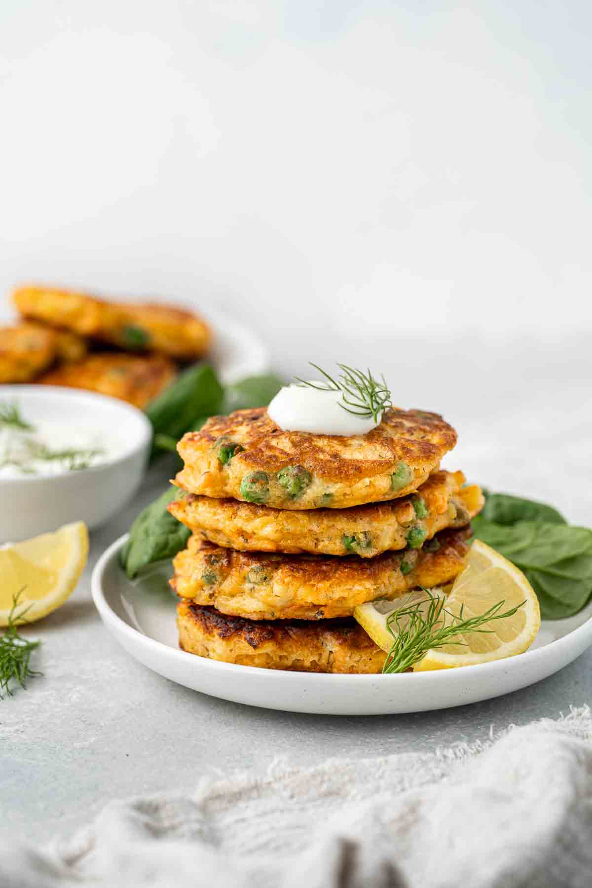 A stack of vegetable fritters on a white plate. 