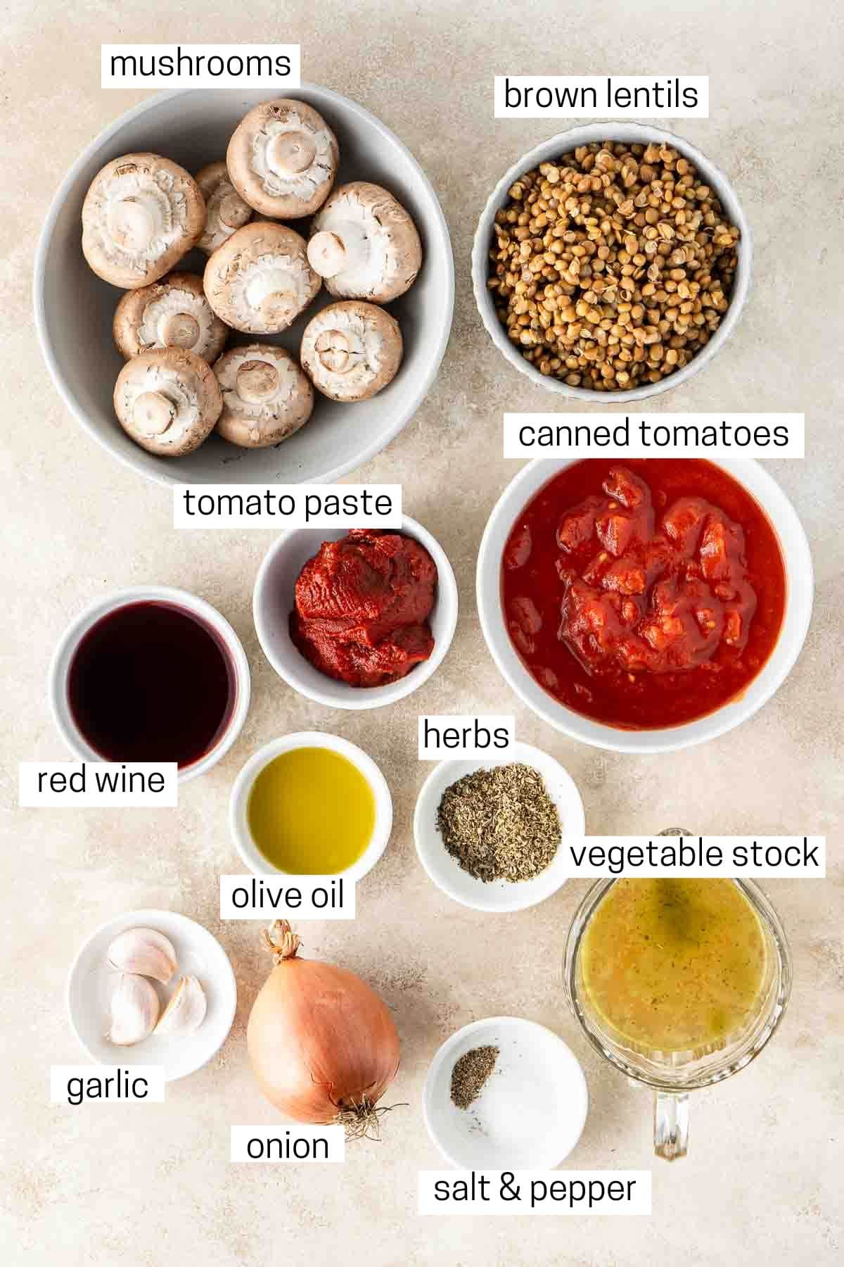 All ingredients needed to make lentil bolognese laid out in bowls.
