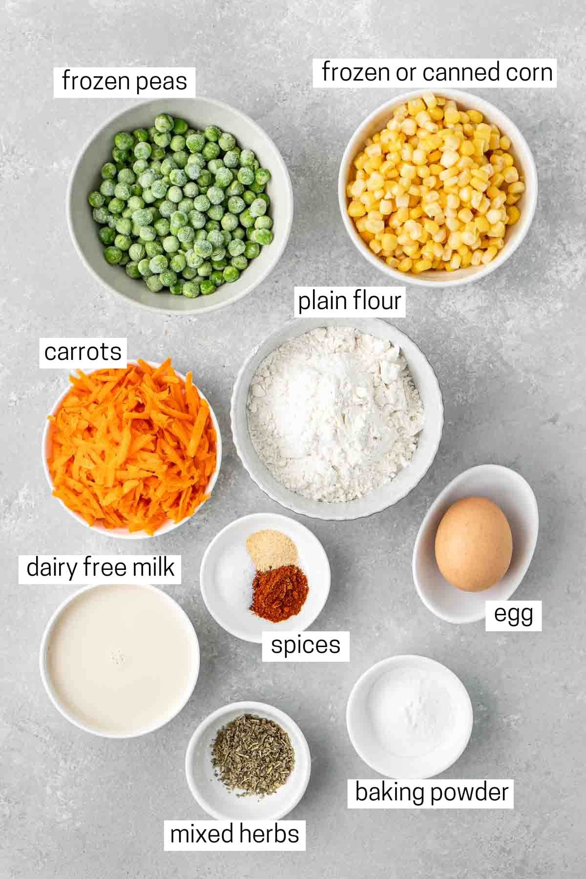 All ingredients needed to make vegetable fritters laid out in bowls.