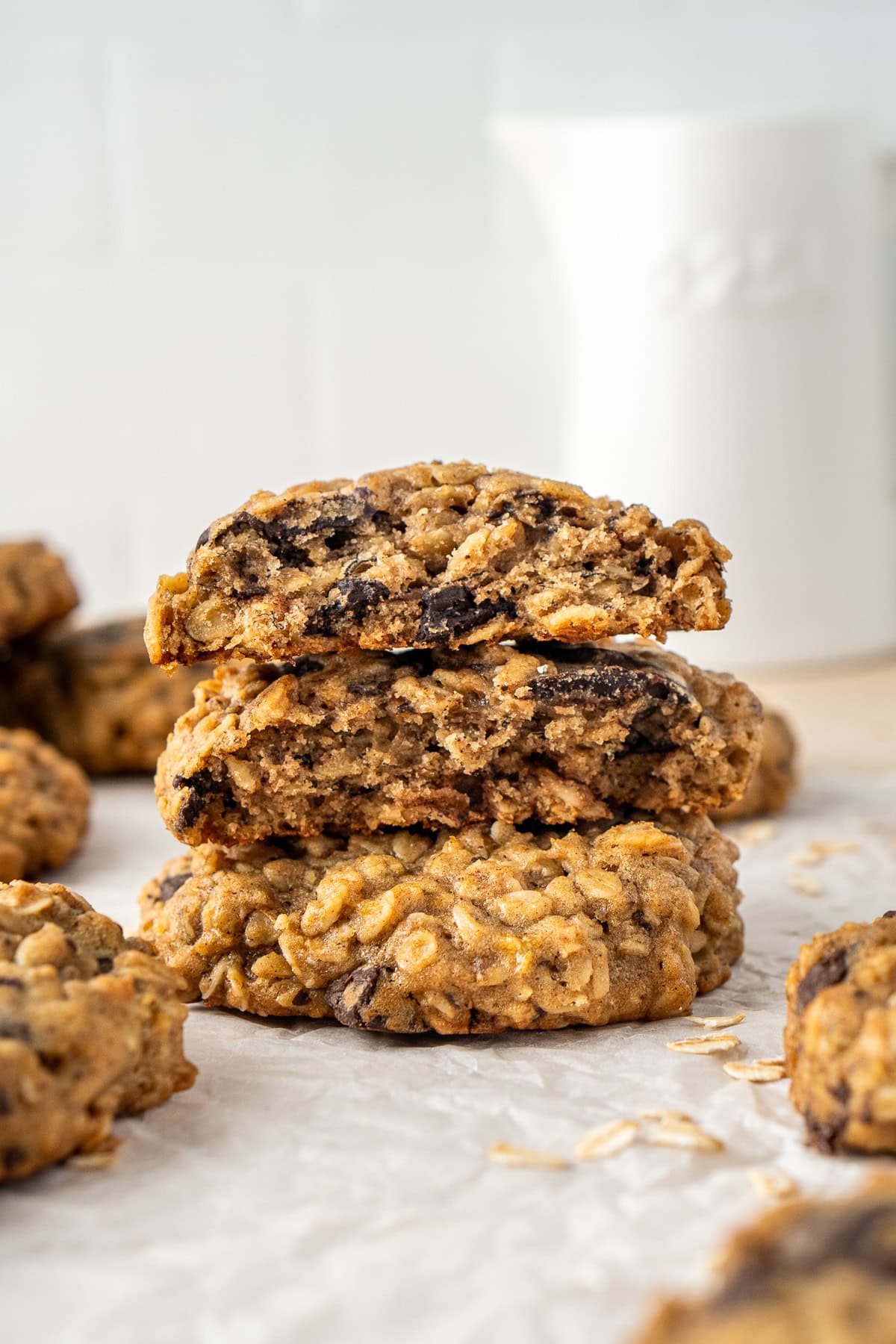 A stack of cookies with one broken in half to show how thick it is. 