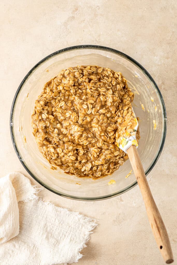 Mixing the oats through the batter with a spatula.