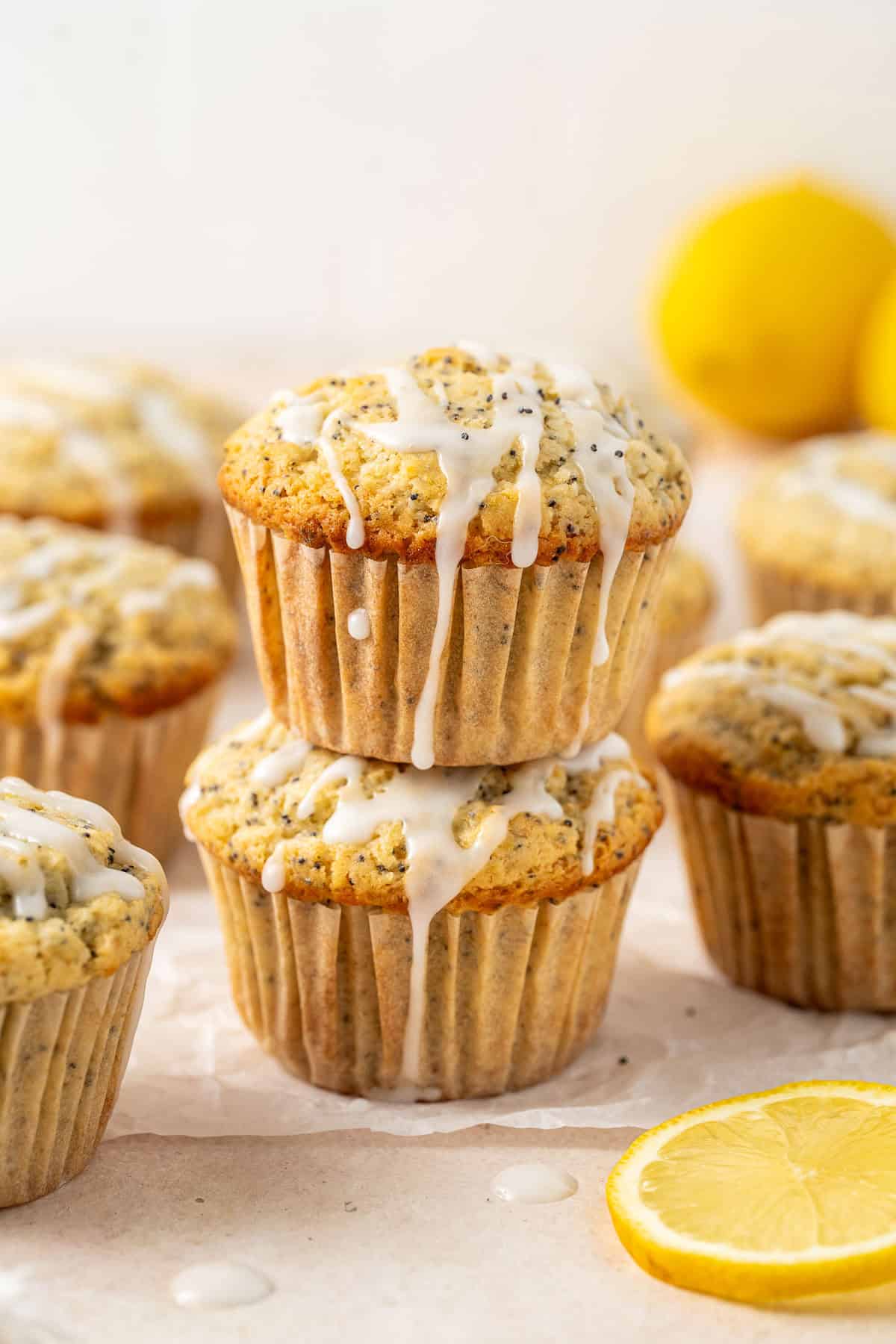 Two dairy free poppy seed muffins stacked on top of each other.
