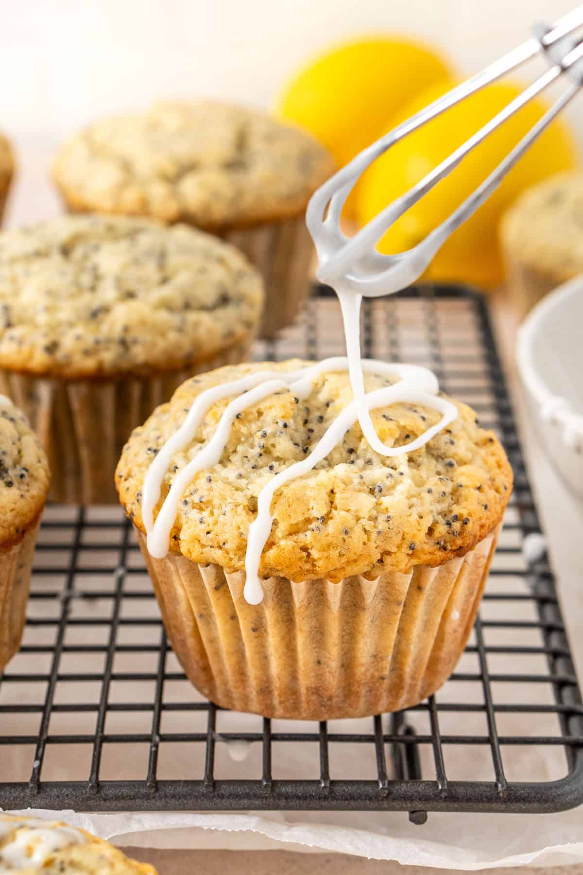 Drizzling the muffins with the lemon glaze.