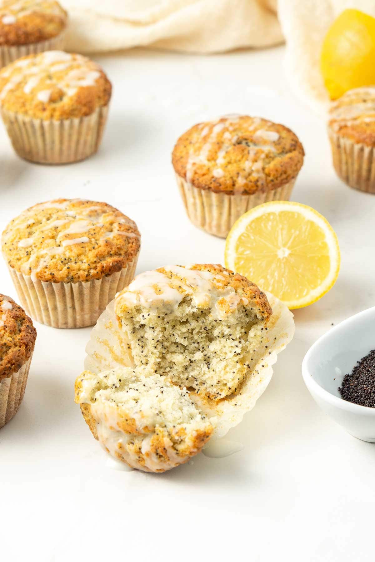 Lemon poppy seed muffins with a bite taken.