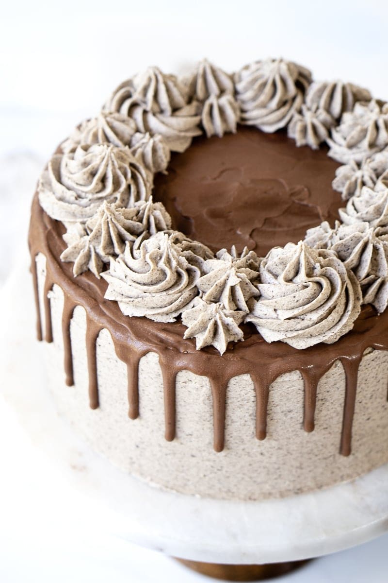 chocolate ganache drop on a cake with buttercream swirls
