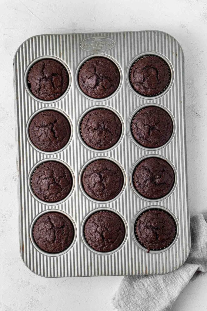 Vegan chocolate cupcakes in a muffin pan.