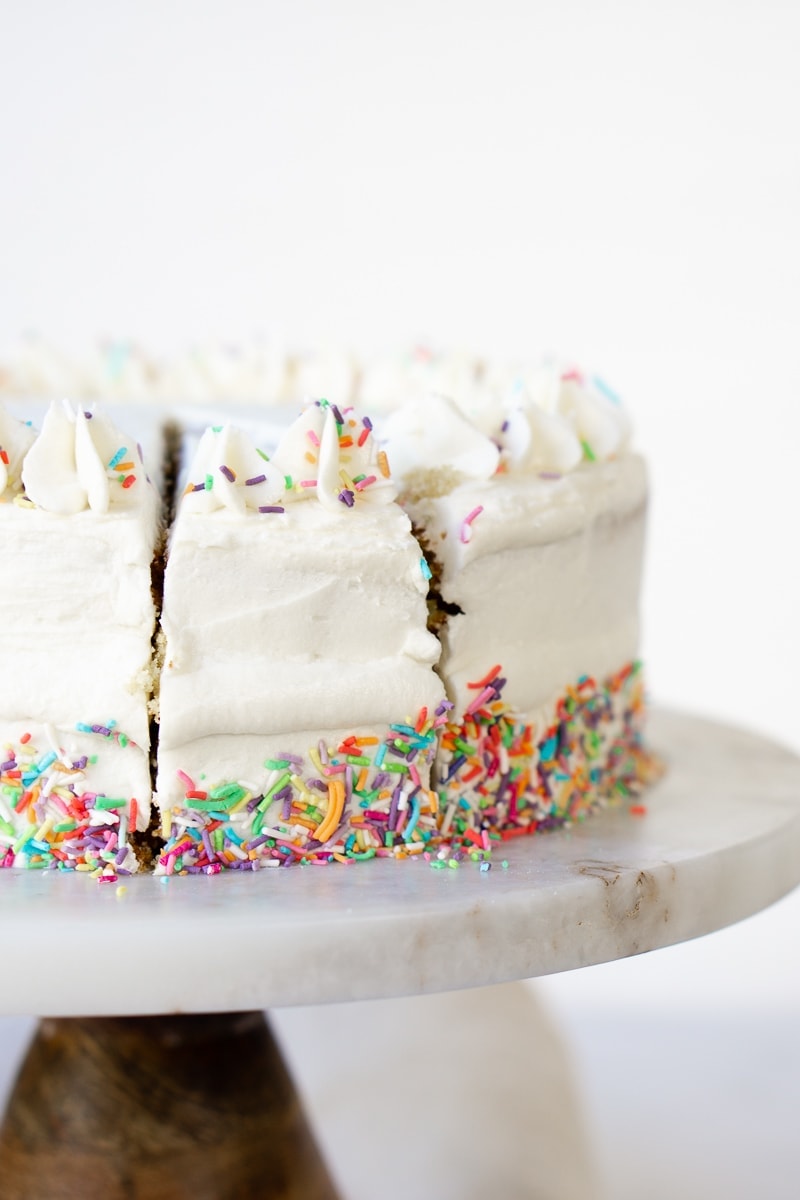 Slicing through rainbow sprinkle cake