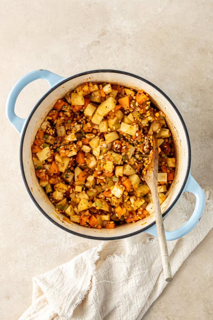 The soup mix and extra vegetables added to the pot.
