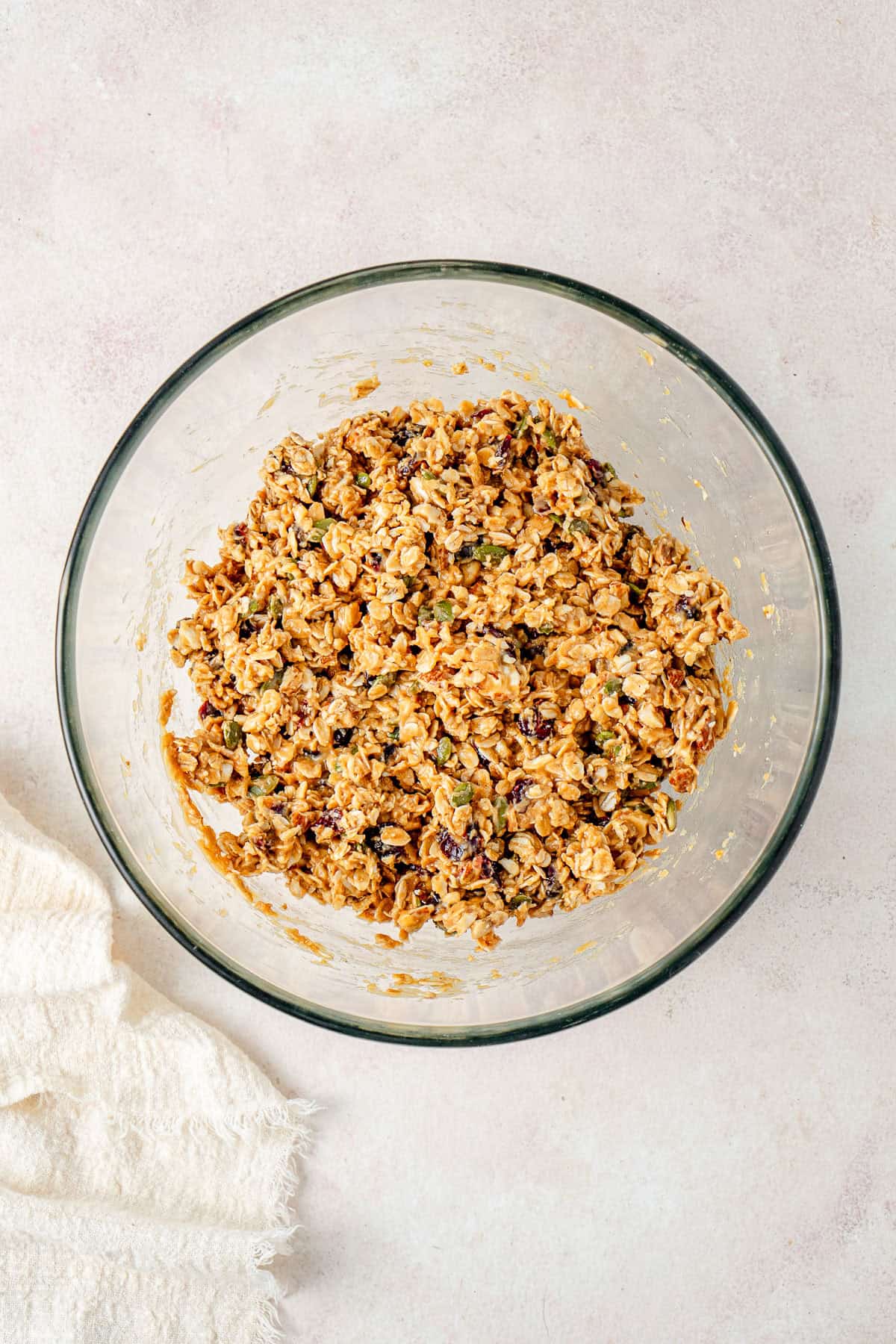 The peanut butter mixture mixed into the muesli in a bowl.