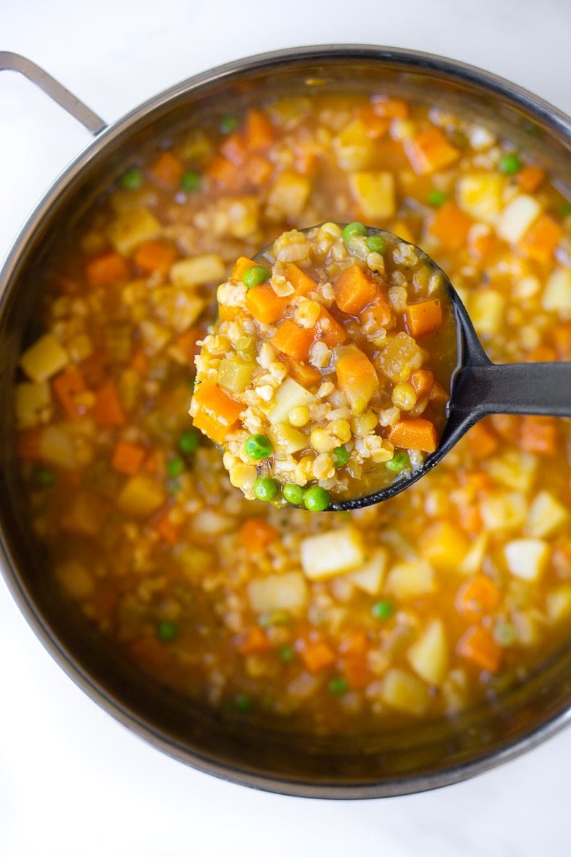 Ladle full of hearty vegetable soup
