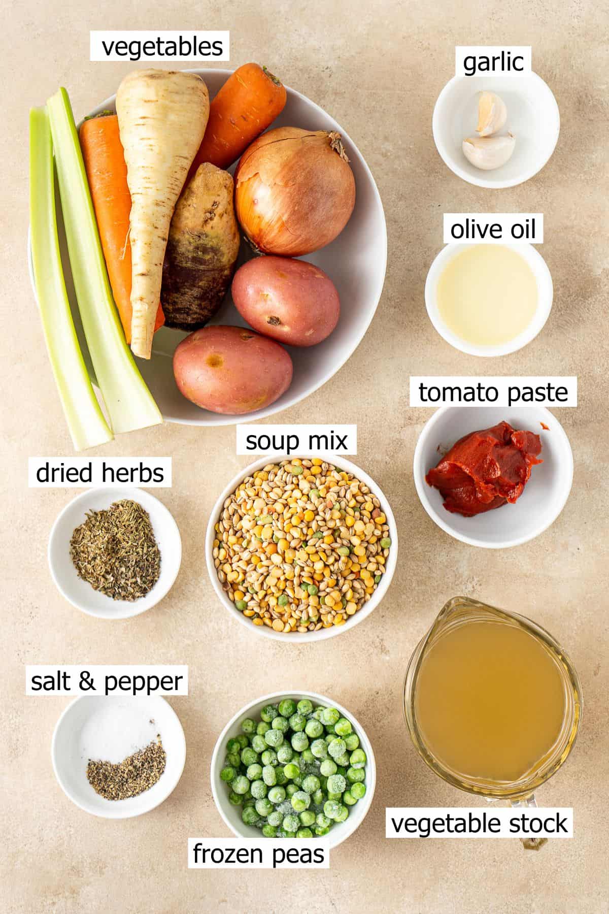 All ingredients needed to make vegetable soup laid out in bowls.