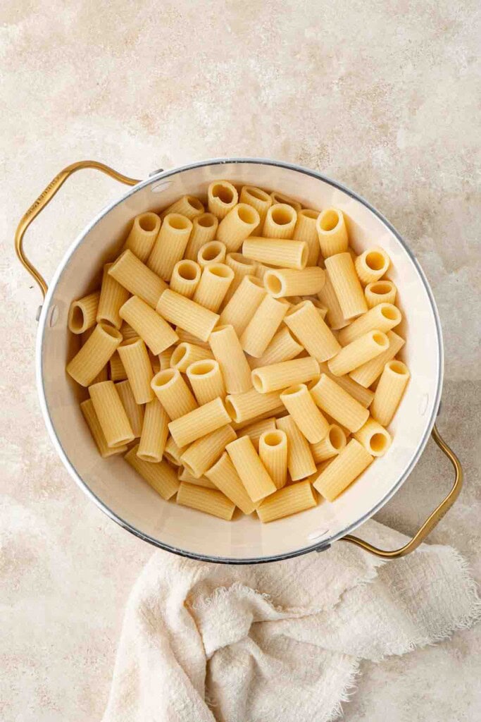 Cooked rigatoni pasta in a pot.