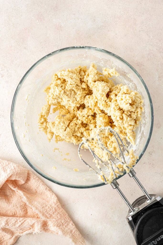 Mixing the cookie dough in a glass bowl.