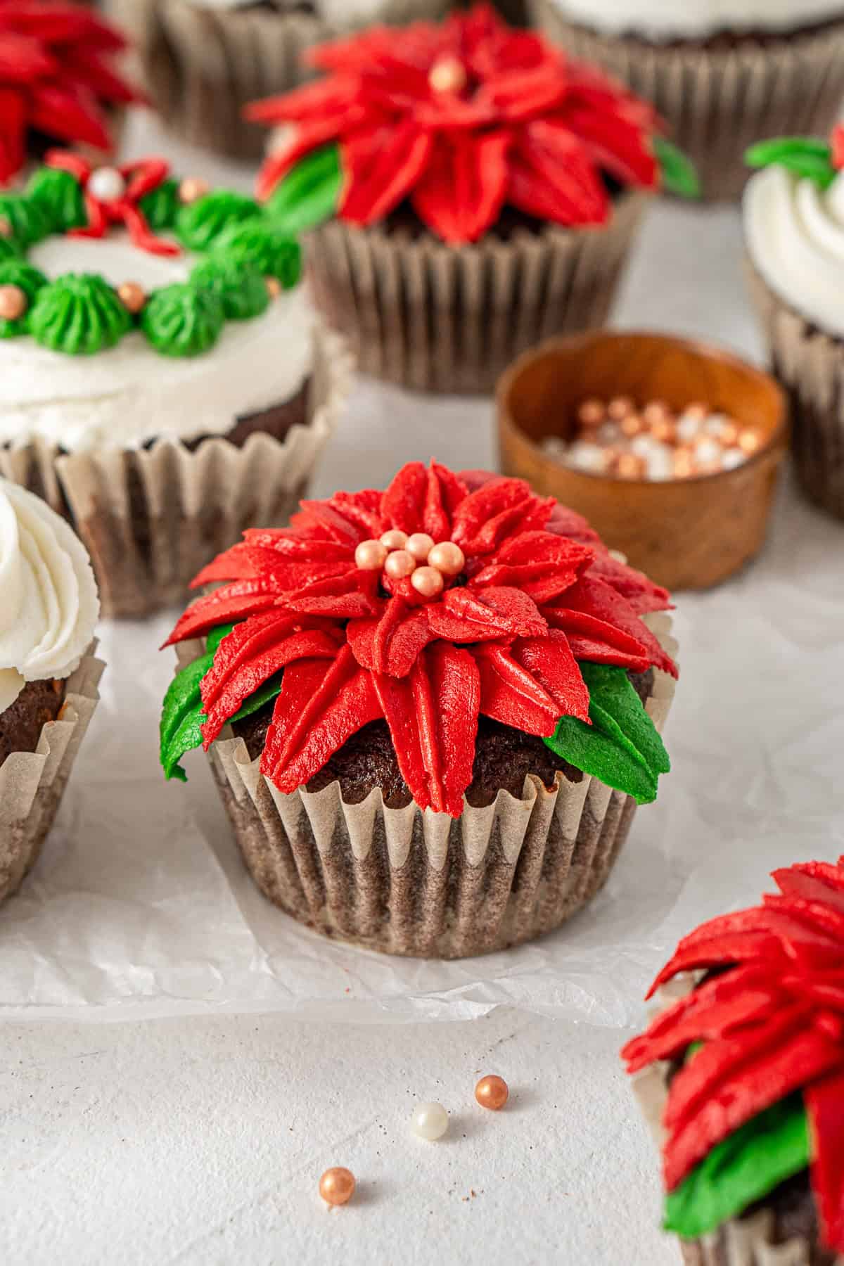 A close up of the poinsettia decorated cupcake.