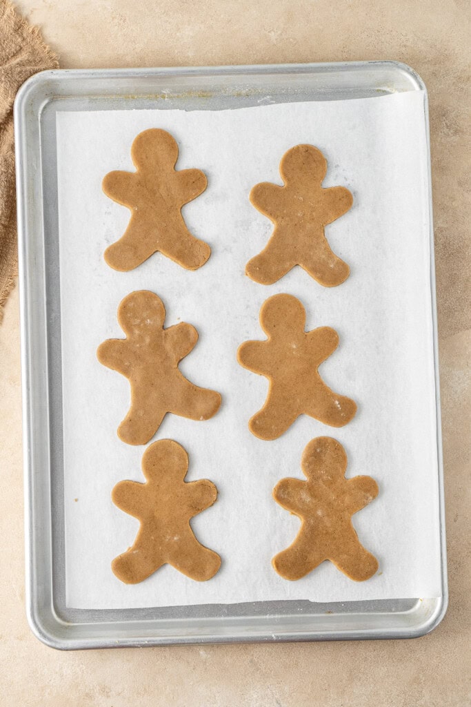 The gingerbread cookies on the baking tray ready for the oven.