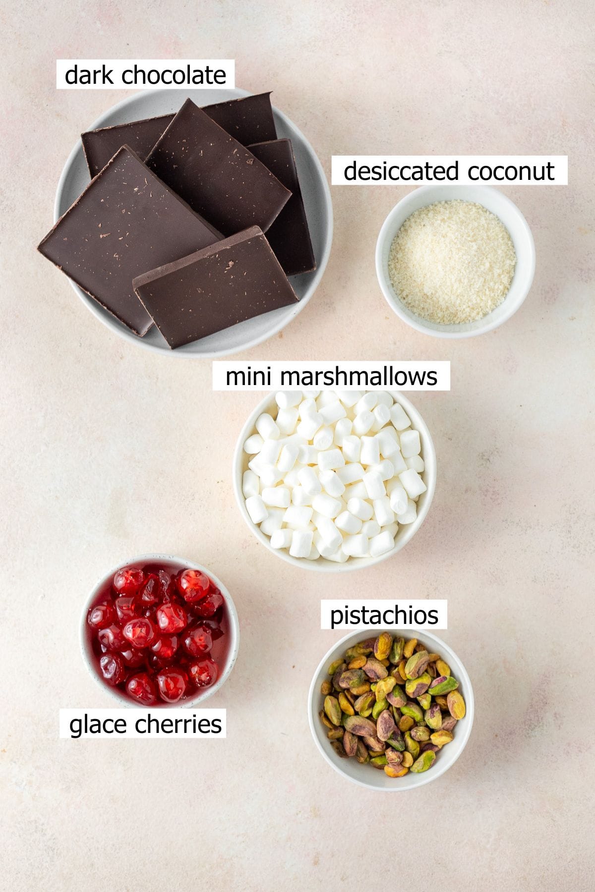 All ingredients needed to make rocky road laid out in small bowls.