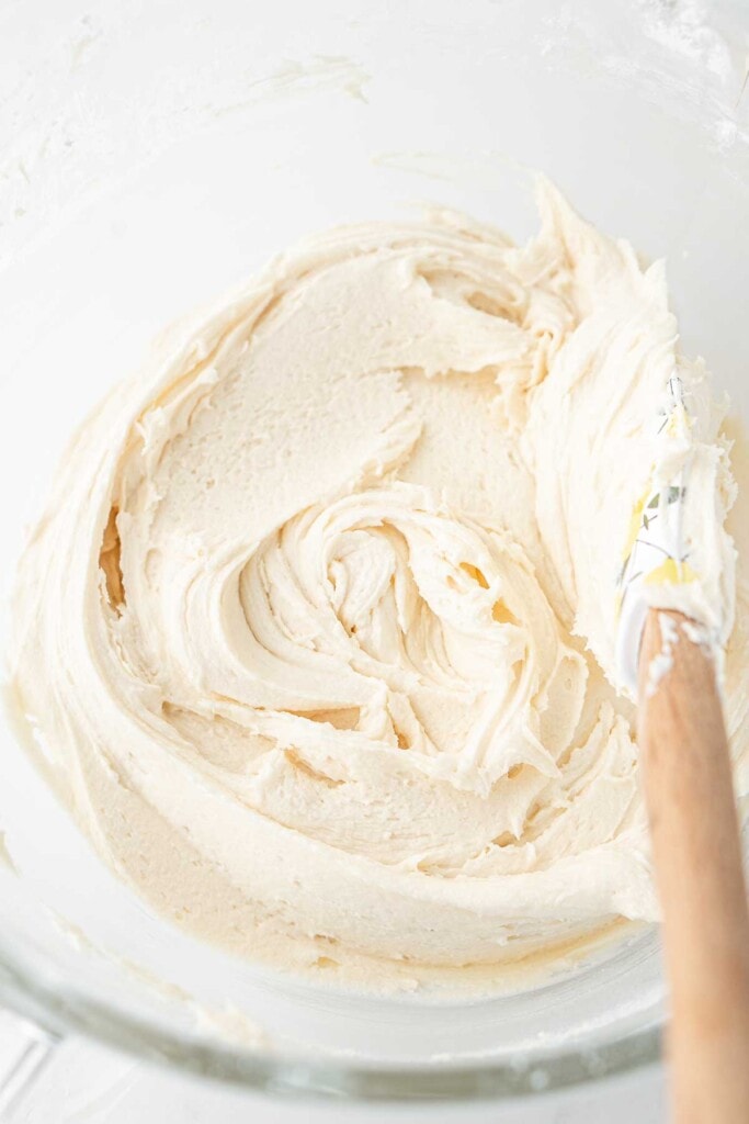 Creamy vegan caramel buttercream in a bowl with a spatula. 