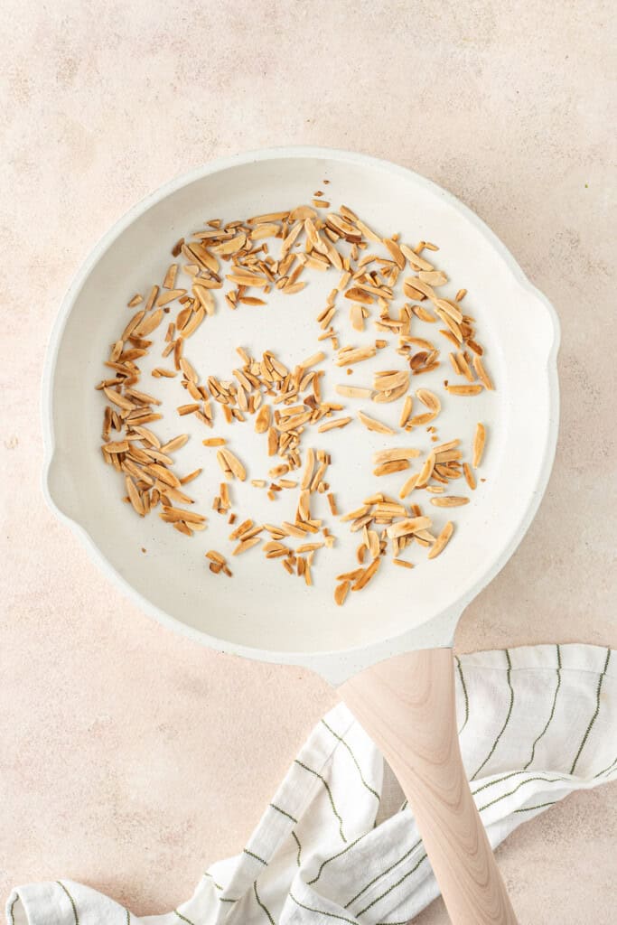 Toasting the almonds in a pan.