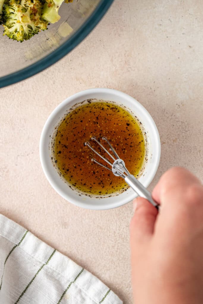 Whisking the dressing ingredients.