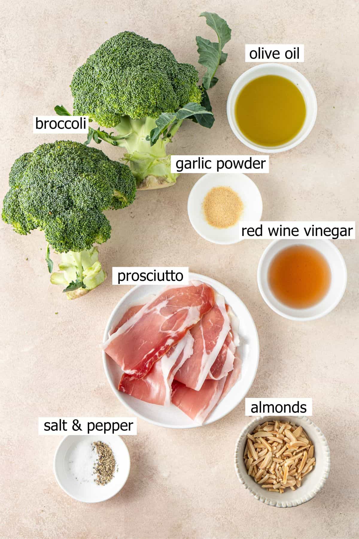 All ingredients needed to make a roasted broccoli salad laid out in small bowls.