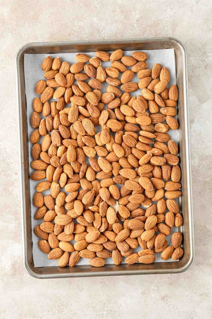 Almonds on a baking tray to be roasted.