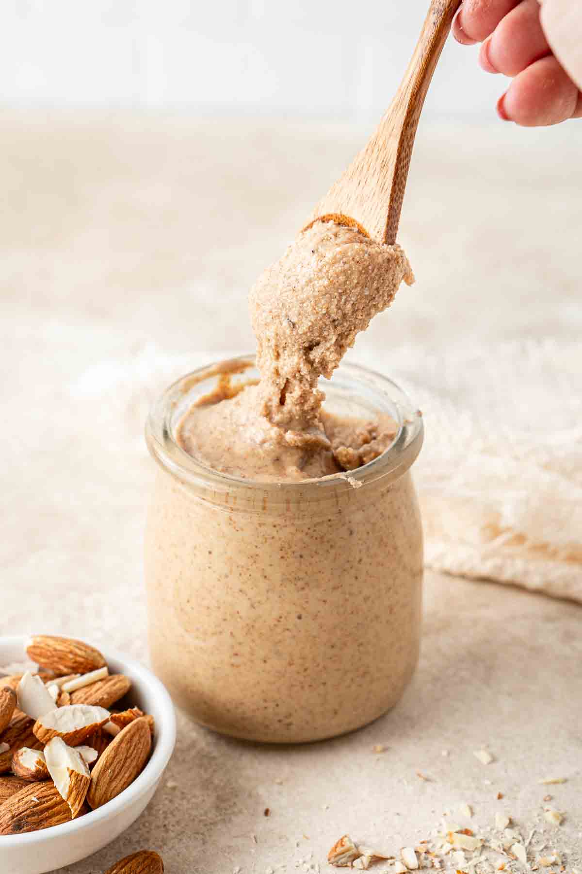 A spoonful of homemade almond butter from a jar.