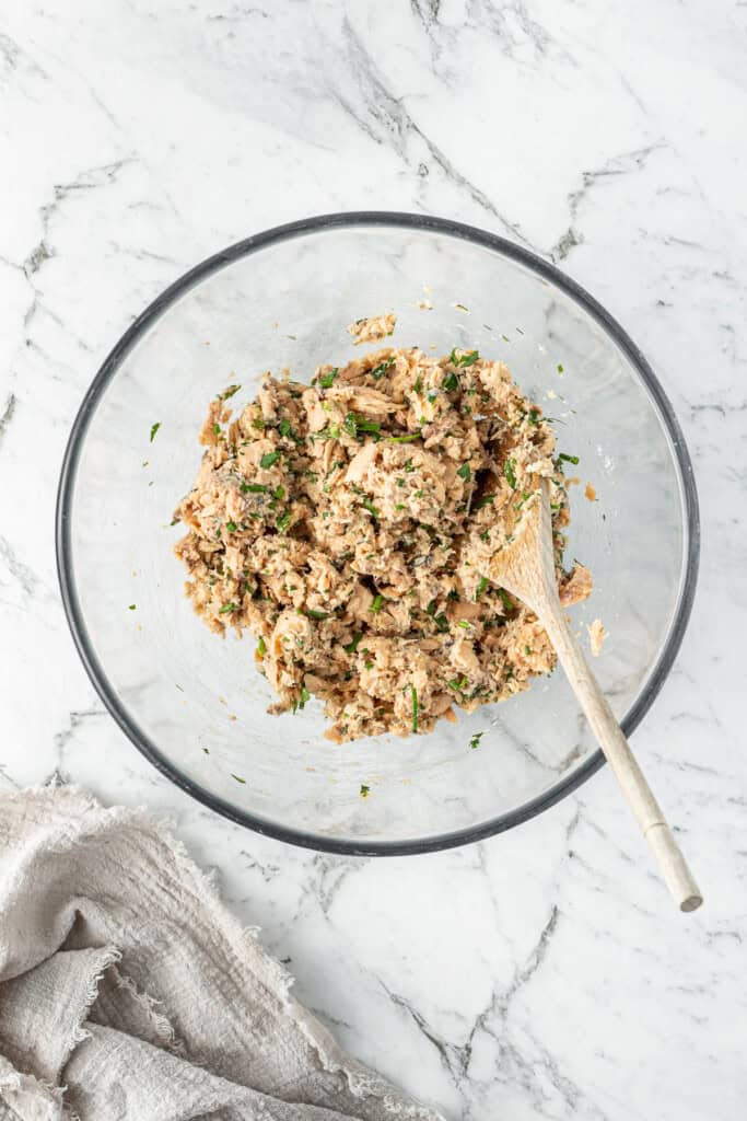 A wooden spoon mixing the ingredients together.