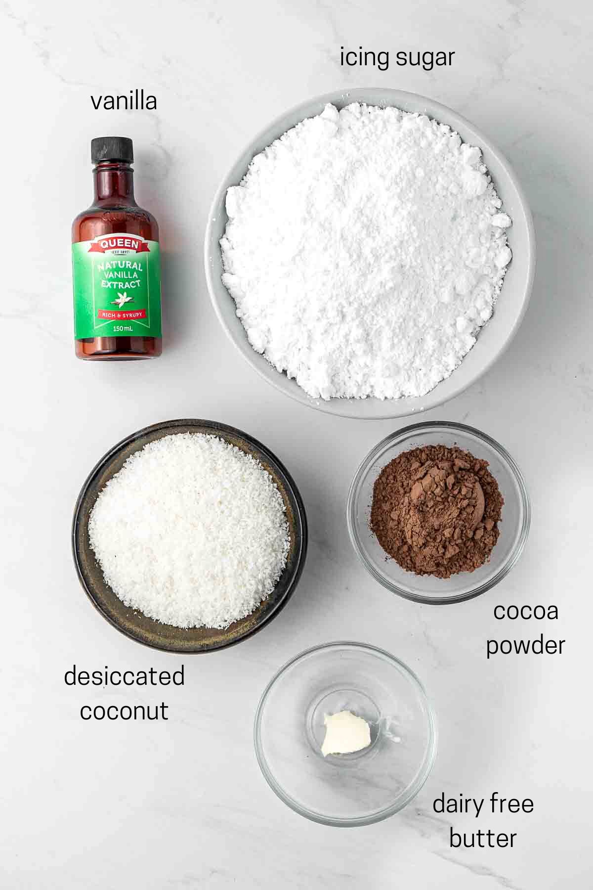 All ingredients needed for lamingtons laid out in small bowls. 