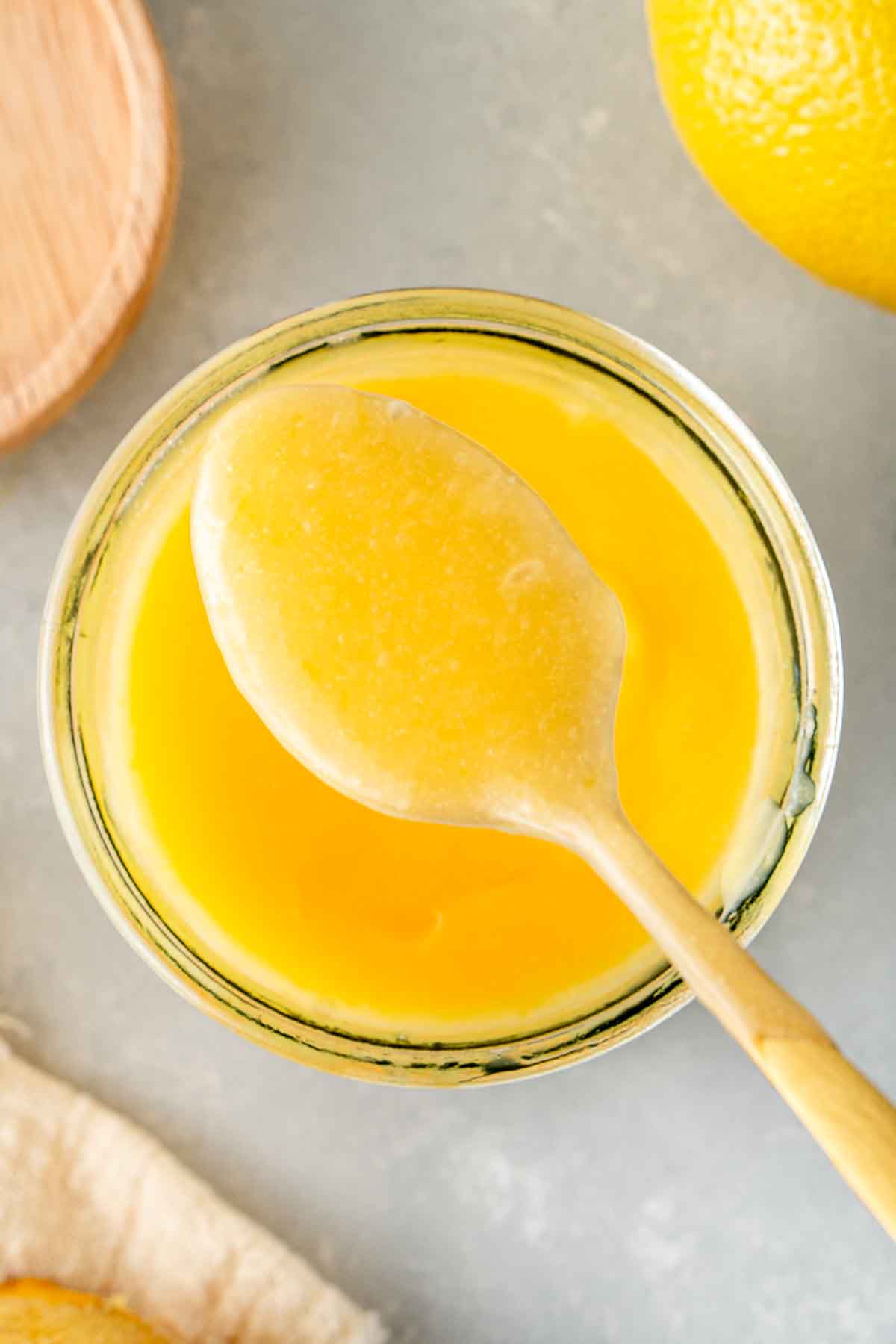 A close up of a spoonful of lemon curd.