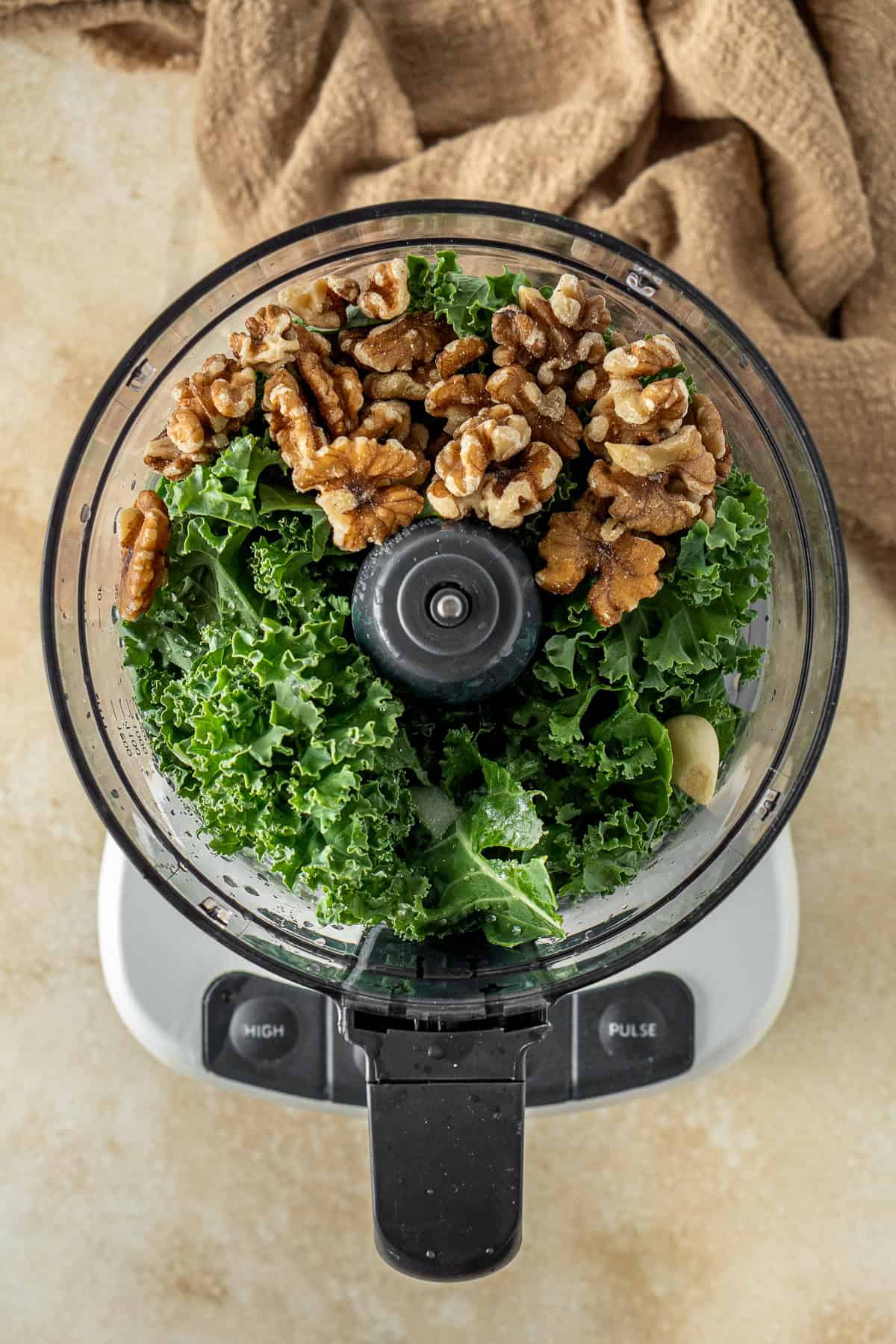 All ingredients needed for the kale pesto in a small food processor.