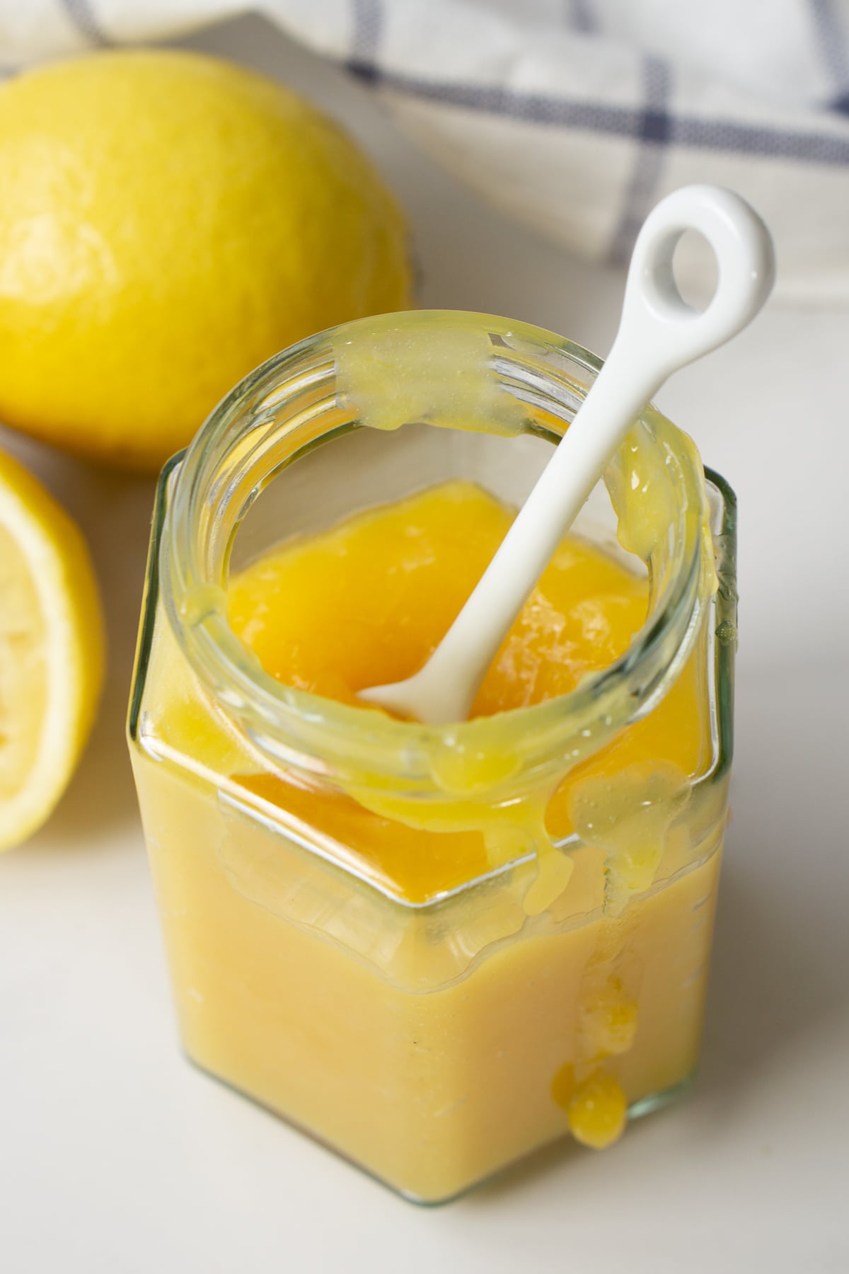 Lemon butter in a jar with a spoon