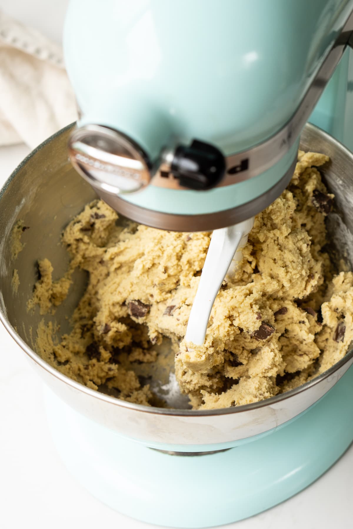 Cookie dough in a Kitchenaid stand mixer.