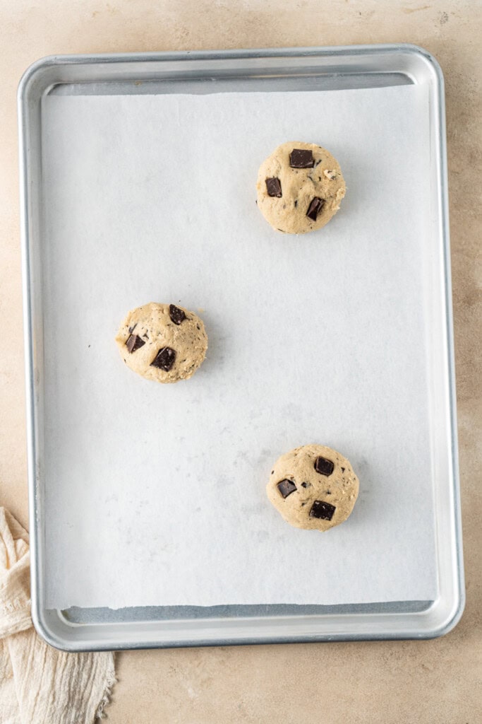 Balls of cookie dough on a baking tray.
