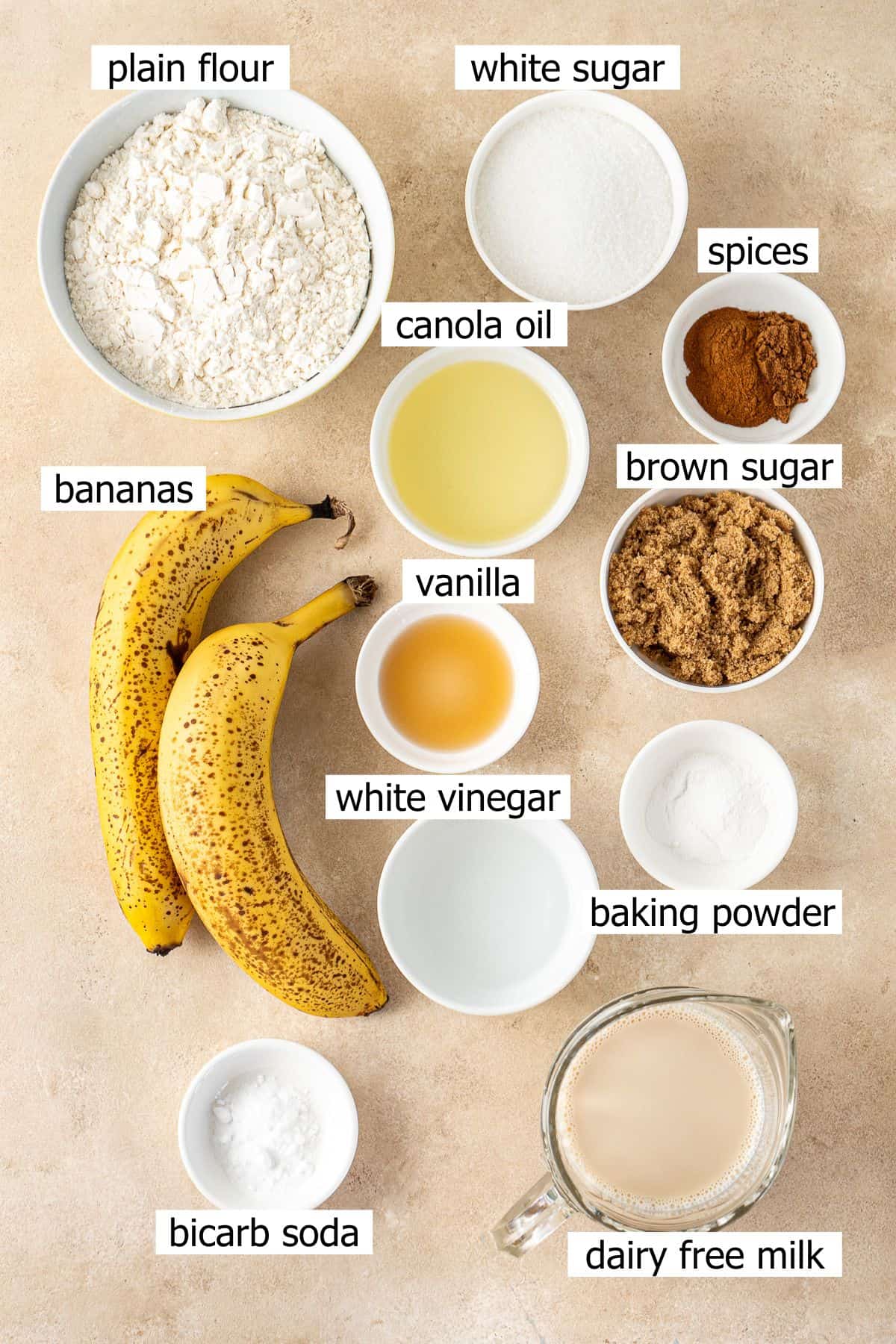 All ingredients needed to make vegan banana cake laid out in bowls.