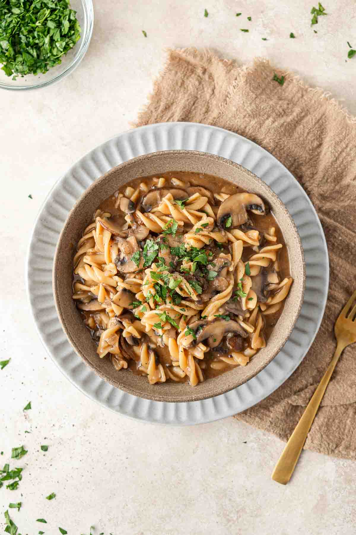Vegan mushroom stroganoff served in a bowl topped with fresh parsley.