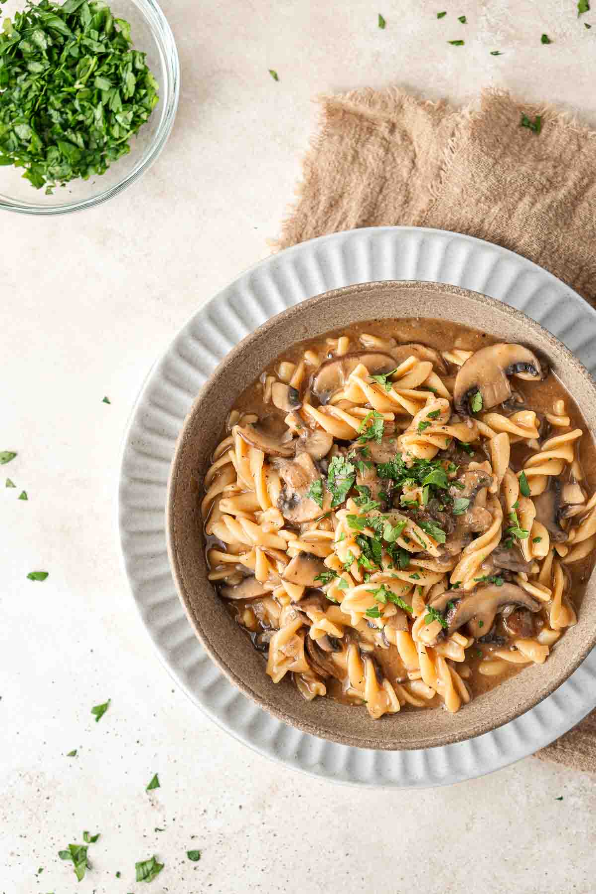 Vegan mushroom stroganoff served in a bowl topped with fresh parsley.