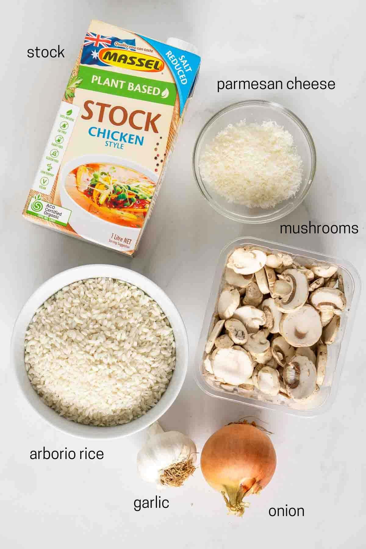 All ingredients needed for pressure cooker mushroom risotto laid out in bowls.