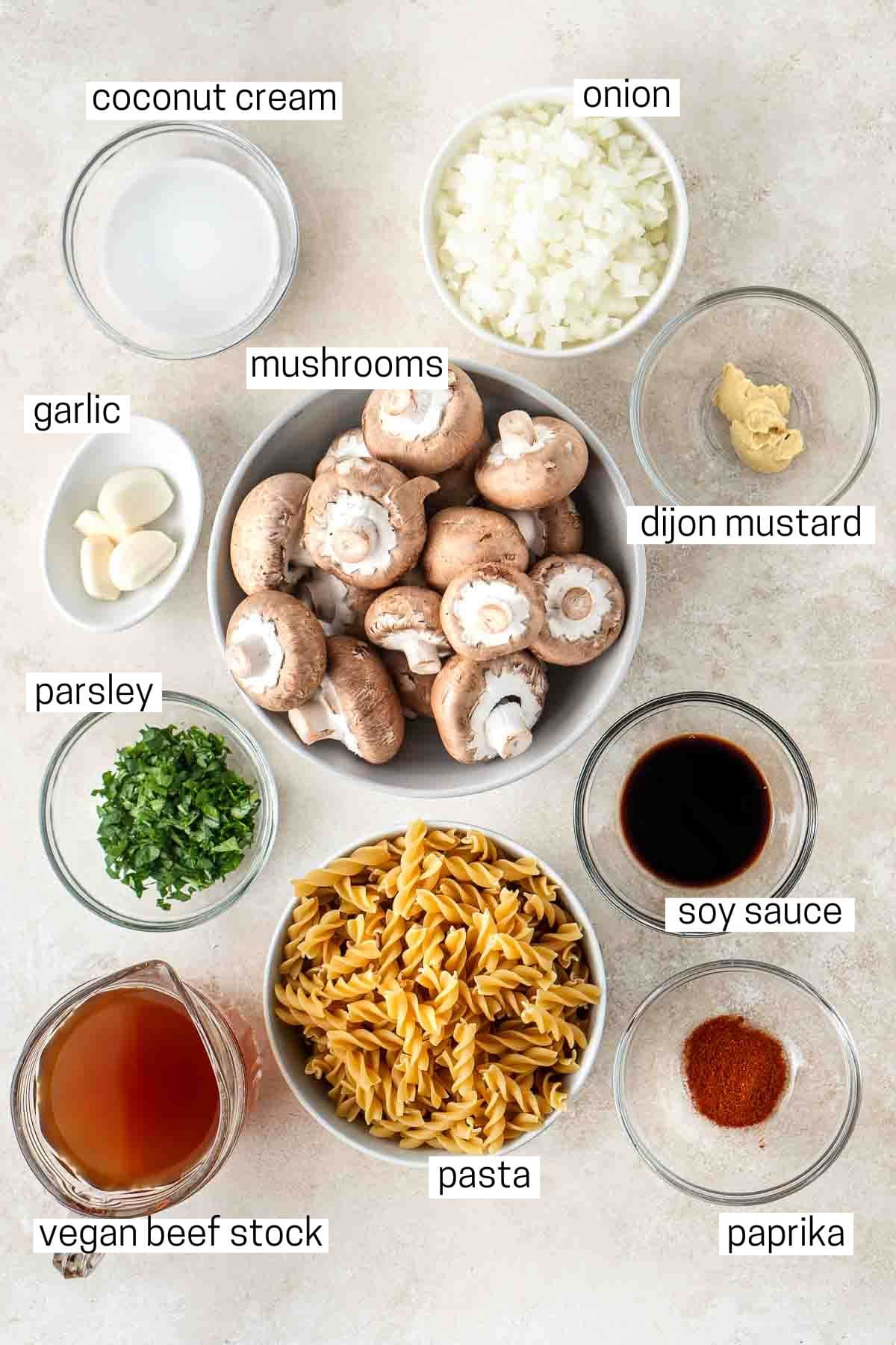 All ingredients needed for mushroom stroganoff laid out in small bowls.
