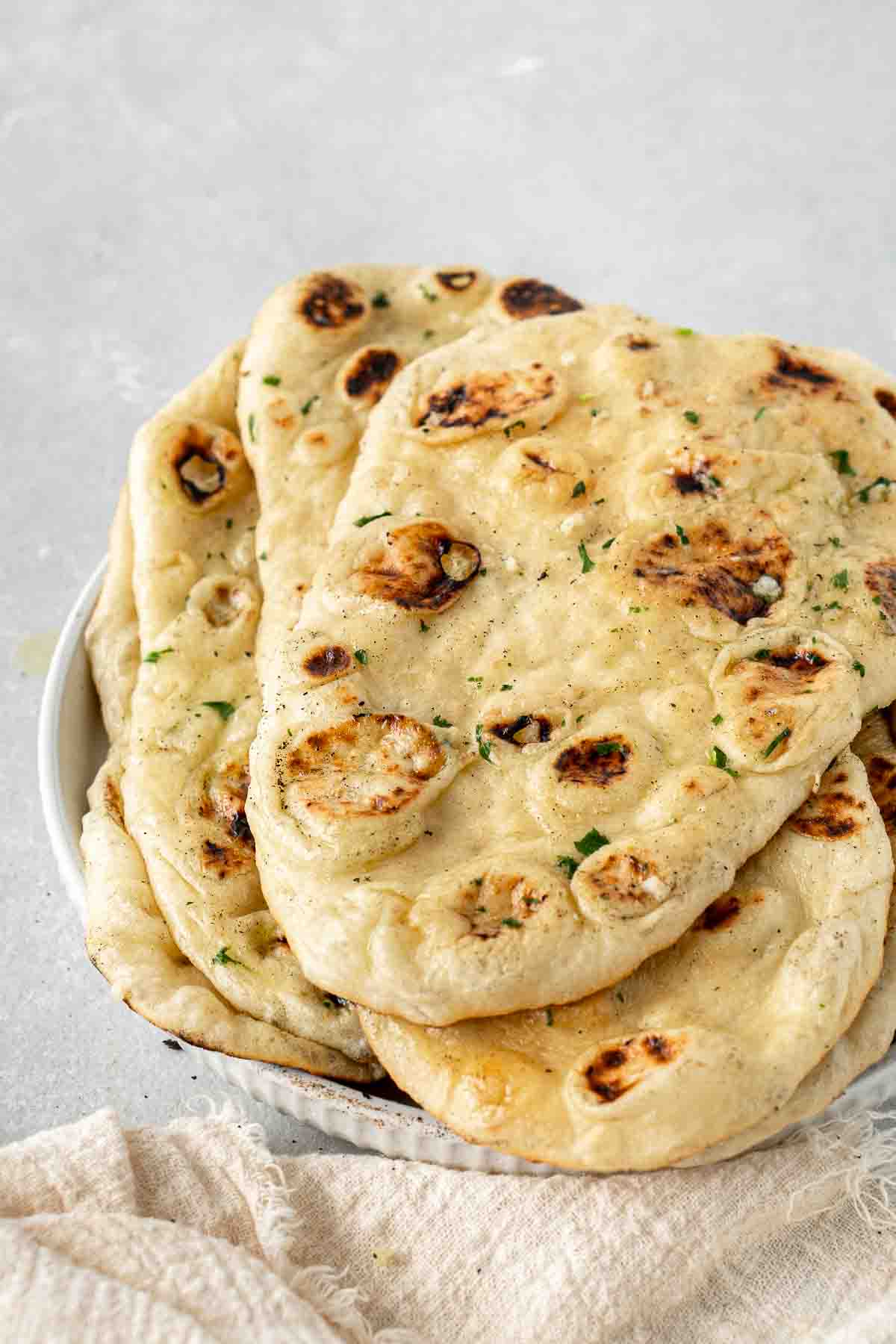 Vegan naans laid out on a plate.
