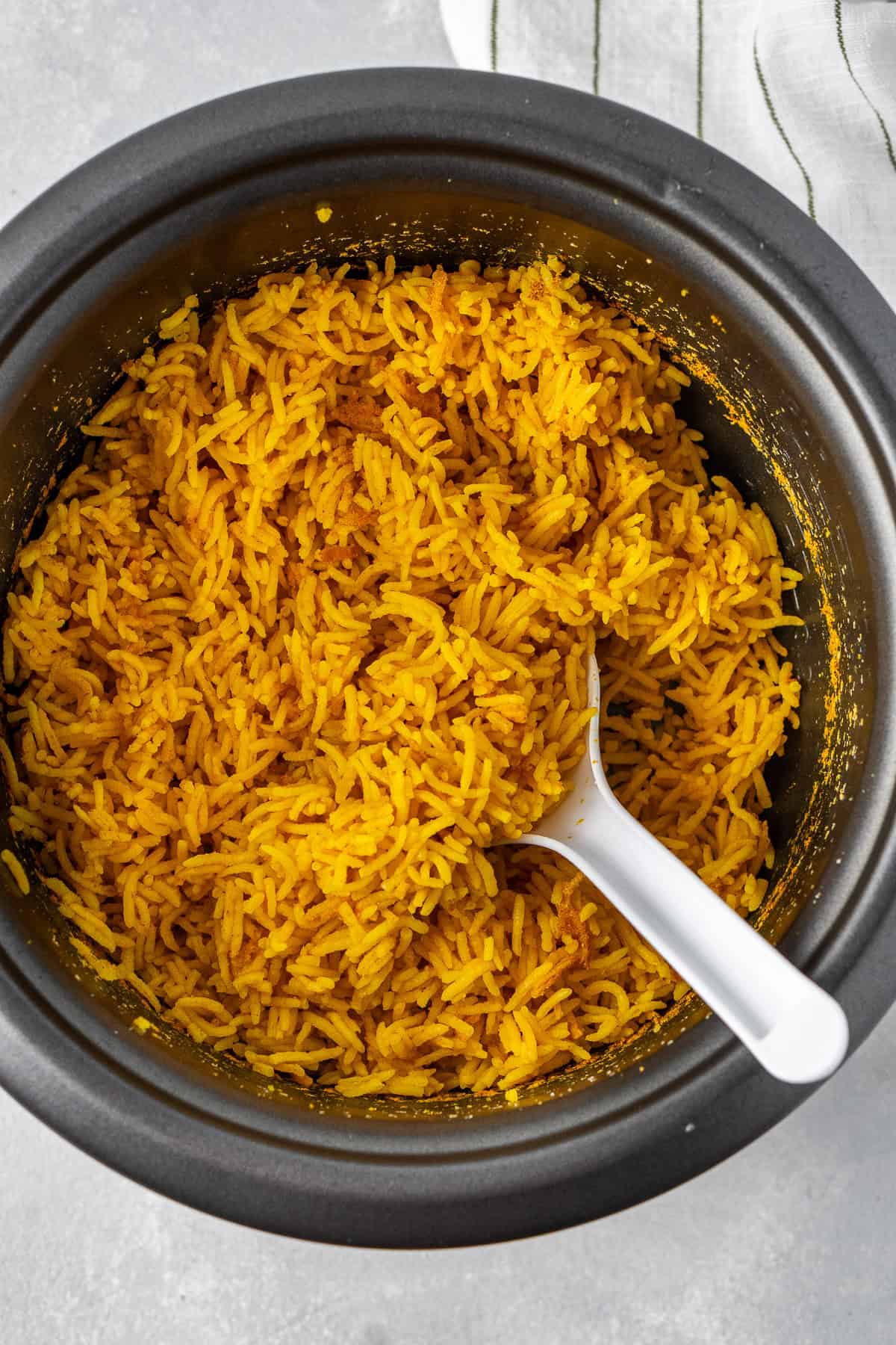 The rice being fluffed with the rice cooker spoon.